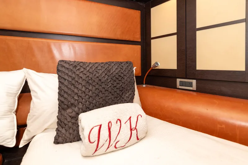 Warren Kelly Yacht Photos Pics Luxurious cabin interior of 2010 Azimut 62S yacht with plush pillows and elegant design.