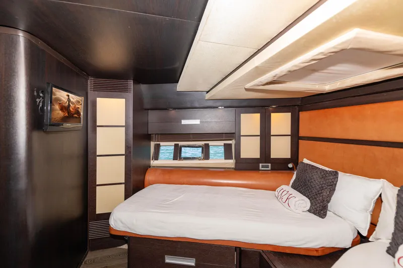 Warren Kelly Yacht Photos Pics Luxurious bedroom interior of 2010 Azimut 62S yacht with modern design and ocean view.