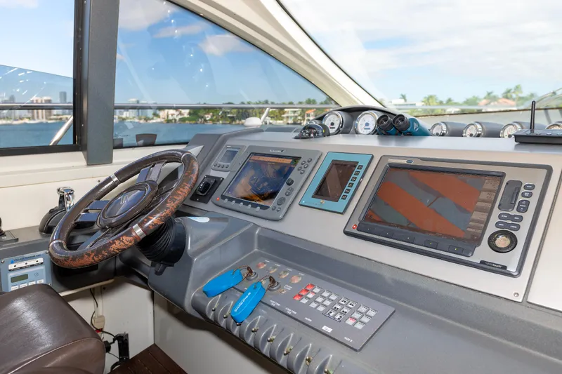 Warren Kelly Yacht Photos Pics Cockpit of 2010 Azimut 62S yacht with navigation instruments and steering wheel.