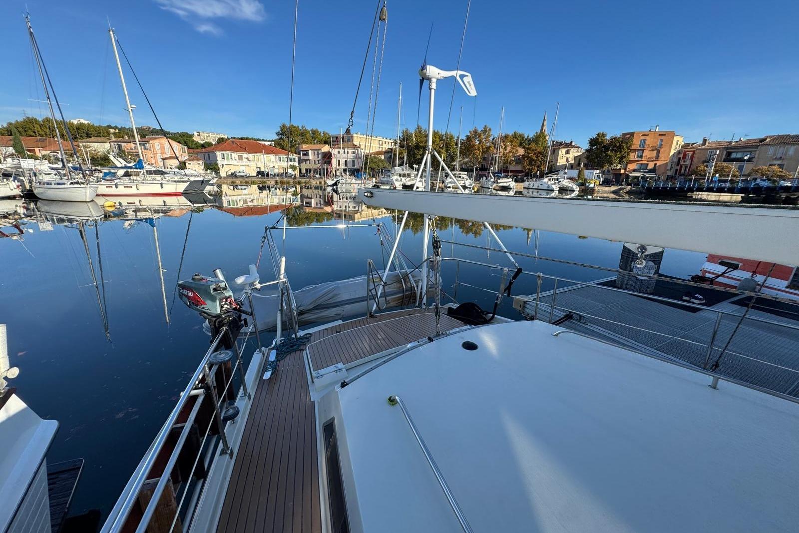 Amel Super Maramu 2000 sailboat docked in a serene marina, 2002 model.