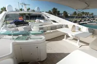 Luxurious 2005 Custom Line 112 yacht deck with elegant seating and modern amenities.