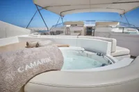 Luxurious yacht deck with jacuzzi, Custom Line 112, 2005 model, featuring elegant seating and towels.
