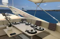 Luxurious yacht deck dining area with elegant table setting, Custom Line 112, 2005 model.