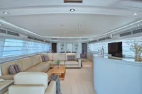 Luxurious interior of 2005 Custom Line 112 yacht with elegant seating and modern decor.