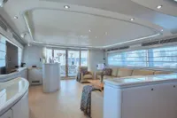 Luxurious interior of 2005 Custom Line 112 yacht with modern furnishings and ample natural light.
