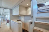 Luxurious yacht interior with modern staircase and sleek cabinetry, Custom Line 112, 2005 model.