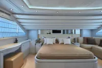Luxurious yacht bedroom interior with modern design, featuring a comfortable bed and elegant seating area.