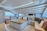 Luxurious yacht bedroom interior with modern design, featuring a large bed and elegant seating area.