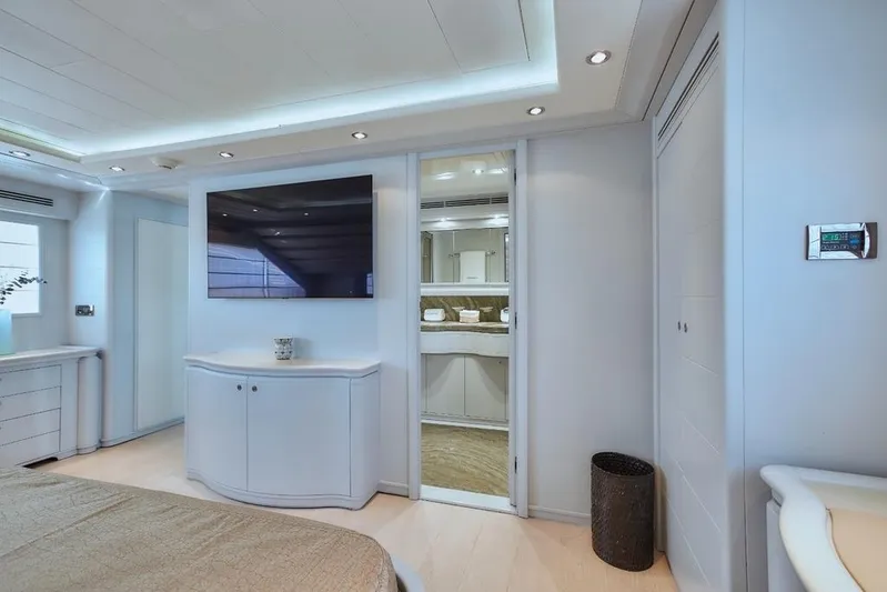 Camarik Yacht Photos Pics Luxurious yacht interior with modern decor, featuring a wall-mounted TV and sleek cabinetry.