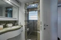 Luxurious yacht bathroom with modern shower, elegant sink, and stylish decor, Custom Line 112, 2005.