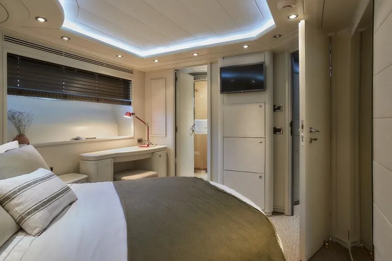 Camarik Yacht Photos Pics Luxurious bedroom interior on 2005 Custom Line 112 yacht, featuring modern design and ambient lighting.