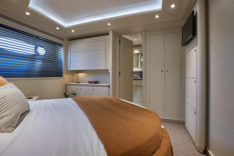 Camarik Yacht Photos Pics Luxurious yacht bedroom with modern design, featuring cozy bedding and ambient lighting, Custom Line 112, 2005.