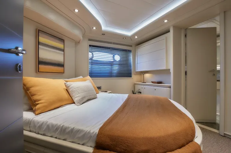 Camarik Yacht Photos Pics Luxurious bedroom interior on 2005 Custom Line 112 yacht, featuring modern decor and ambient lighting.