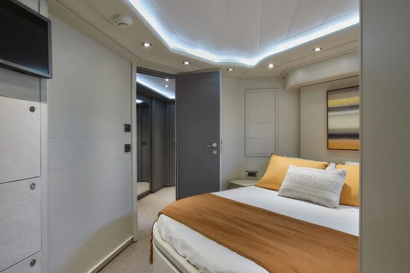 Camarik Yacht Photos Pics Luxurious bedroom interior on a 2005 Custom Line 112 yacht, featuring modern design and ambient lighting.