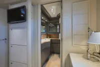 Luxurious yacht interior with modern bathroom, TV, and elegant lighting, Custom Line 112, 2005 model.