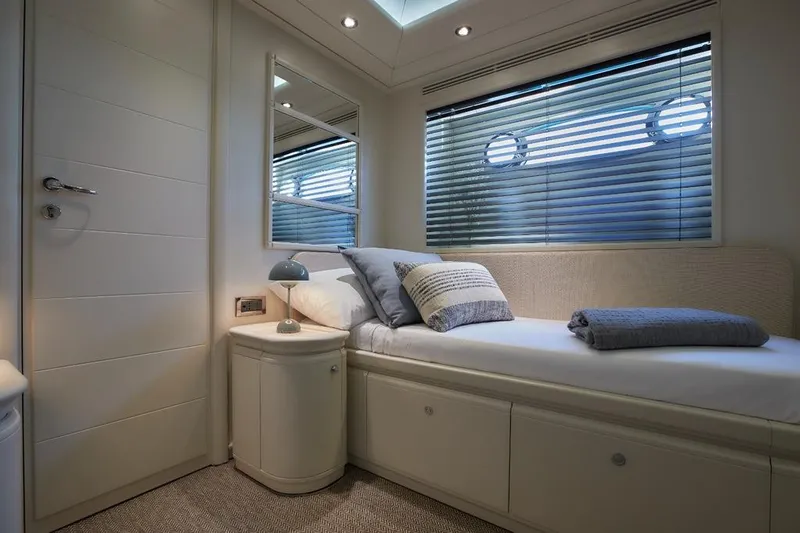 Camarik Yacht Photos Pics Luxurious yacht cabin interior with bed, pillows, and porthole windows, Custom Line 112, 2005.
