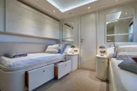 Luxurious yacht bedroom with twin beds, elegant decor, and soft lighting, Custom Line 112, 2005.