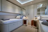 Luxurious twin cabin interior on 2005 Custom Line 112 yacht, featuring elegant decor and modern amenities.