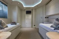 Luxurious yacht cabin with twin beds, modern design, and ambient lighting, Custom Line 112, 2005.