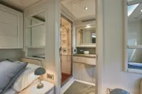 Luxurious yacht interior with elegant bedroom and modern en-suite bathroom, Custom Line 112, 2005.
