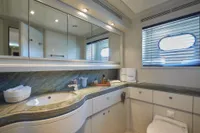 Luxurious yacht bathroom with modern fixtures, marble countertop, and mirrored cabinets, Custom Line 112, 2005.