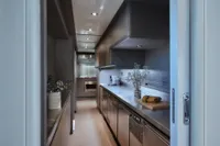 Luxurious yacht kitchen with modern appliances, sleek cabinetry, and elegant decor, Custom Line 112, 2005.