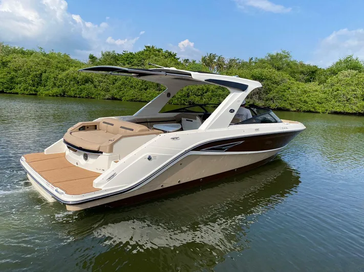 2017 Sea Ray 310 Slx @ Puerto Vallarta Yacht Photos Pics 2017 Sea Ray 310 SLX boat cruising on a calm river with lush greenery.