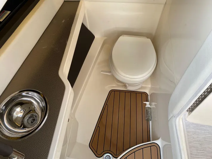 2017 Sea Ray 310 Slx @ Puerto Vallarta Yacht Photos Pics 2017 Sea Ray 310 SLX boat bathroom with toilet, sink, and wooden floor mat.