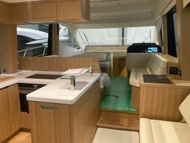  Yacht Photos Pics Luxurious interior of 2024 Galeon 500 Fly yacht with modern kitchen and seating area.