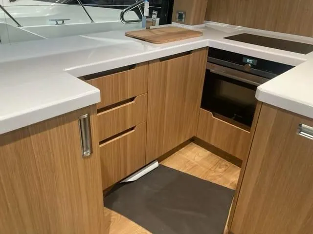  Yacht Photos Pics Modern kitchen interior on 2024 Galeon 500 Fly yacht with wood cabinetry and sleek countertops.