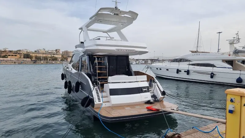  Yacht Photos Pics 2024 Galeon 500 Fly yacht docked at marina, showcasing sleek design and modern features.