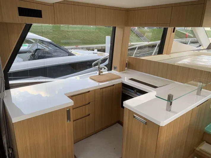  Yacht Photos Pics Modern kitchen interior on 2024 Galeon 500 Fly yacht with sleek countertops and wood cabinetry.