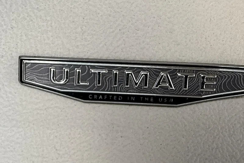  Yacht Photos Pics 2024 Regal LX9 "Ultimate" badge, crafted in the USA, on textured surface.