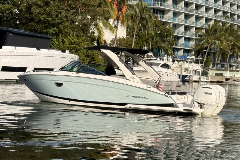  Yacht Photos Pics 2024 Regal LX9 boat on water, featuring sleek design and Yamaha outboard engine.