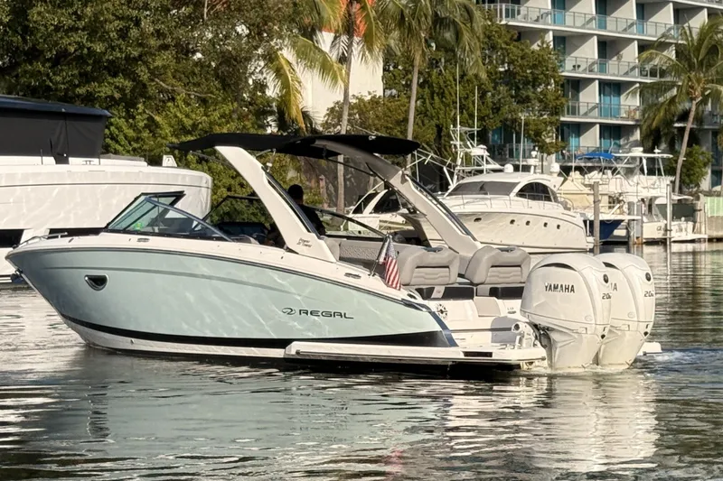  Yacht Photos Pics 2024 Regal LX9 boat with Yamaha engines docked in a marina.