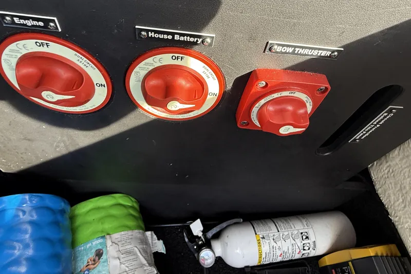  Yacht Photos Pics Control panel with red switches for engine, house battery, and bow thruster on a 2024 Regal LX9.