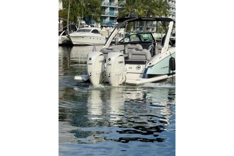  Yacht Photos Pics 2024 Regal LX9 boat with dual Yamaha 200 engines docked in marina.