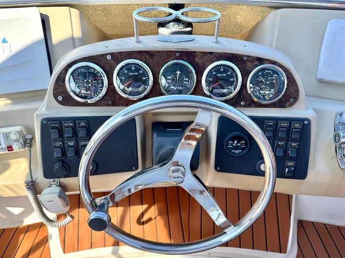Craver Yacht Photos Pics Steering wheel and dashboard of 2001 Carver 396 Motor Yacht with gauges and controls.