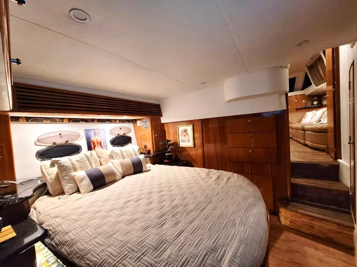 Craver Yacht Photos Pics Luxurious bedroom interior of 2001 Carver 396 Motor Yacht with elegant bedding and wood accents.