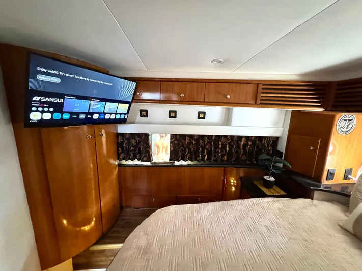 Craver Yacht Photos Pics Interior of 2001 Carver 396 Motor Yacht with TV and wooden cabinetry.