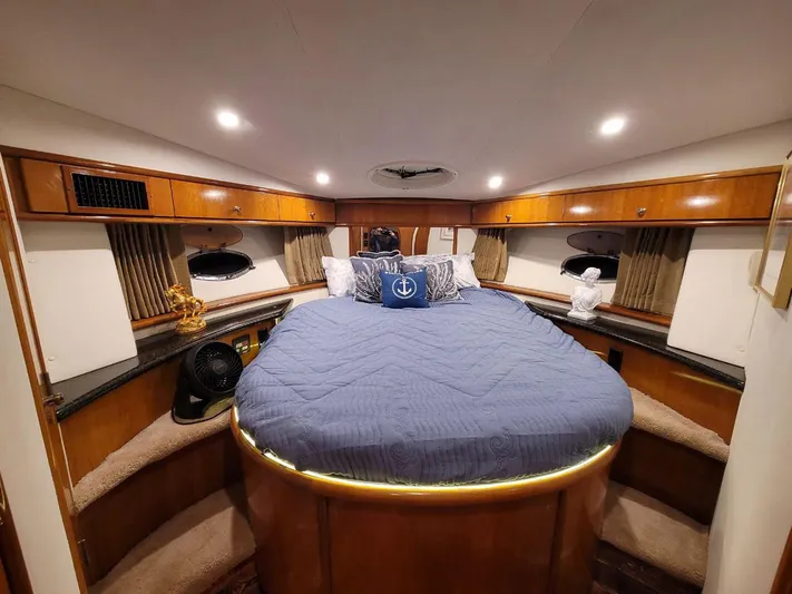 Craver Yacht Photos Pics Luxurious bedroom in 2001 Carver 396 Motor Yacht with cozy bedding and elegant wood finish.