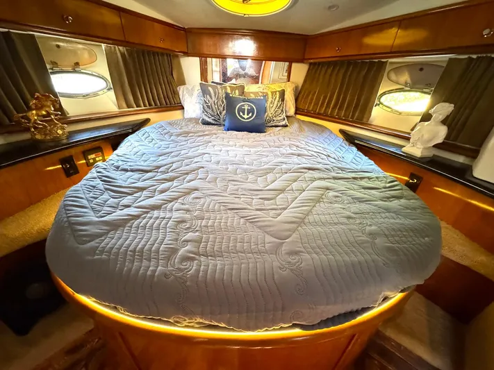 Craver Yacht Photos Pics Luxurious bedroom in 2001 Carver 396 Motor Yacht with elegant bedding and ambient lighting.