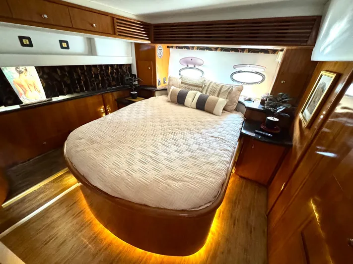 Craver Yacht Photos Pics Luxurious bedroom in 2001 Carver 396 Motor Yacht with elegant wood finishes and ambient lighting.
