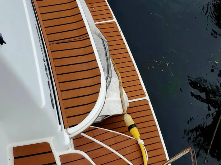 Craver Yacht Photos Pics Carver 396 Motor Yacht 2001 teak deck with water hose by the water.