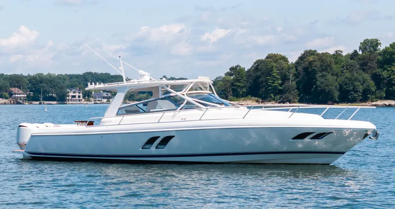 Lil' Sumpin II Yacht Photos Pics 2015 Intrepid 430 Sport Yacht on calm water, surrounded by lush greenery.
