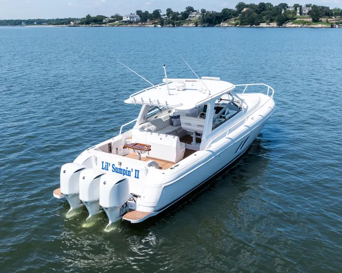 Lil' Sumpin II Yacht Photos Pics 2015 Intrepid 430 Sport Yacht on calm water, rear view with triple engines.