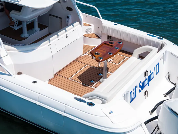 Lil' Sumpin II Yacht Photos Pics 2015 Intrepid 430 Sport Yacht deck with seating and table, on water.