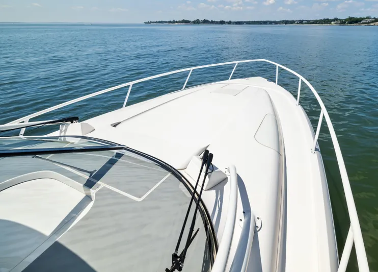 Lil' Sumpin II Yacht Photos Pics 2015 Intrepid 430 Sport Yacht cruising on calm waters under a clear sky.