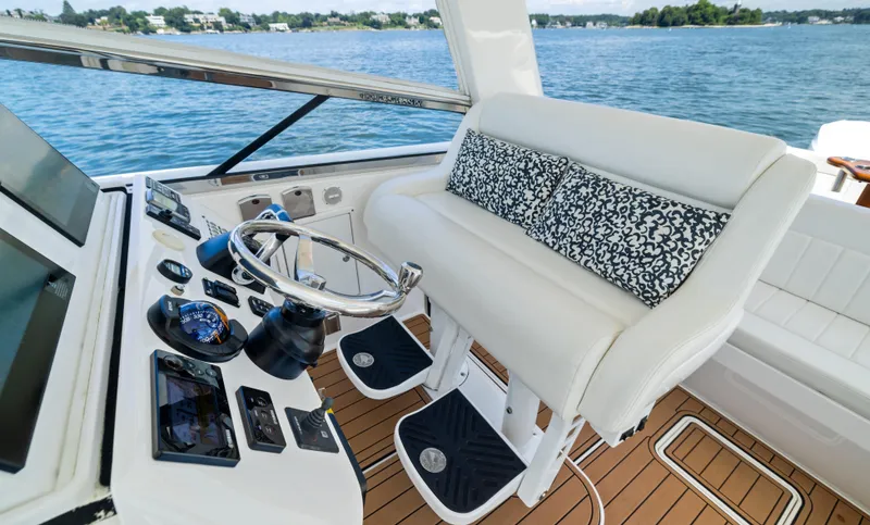 Lil' Sumpin II Yacht Photos Pics 2015 Intrepid 430 Sport Yacht helm with white seating and ocean view.