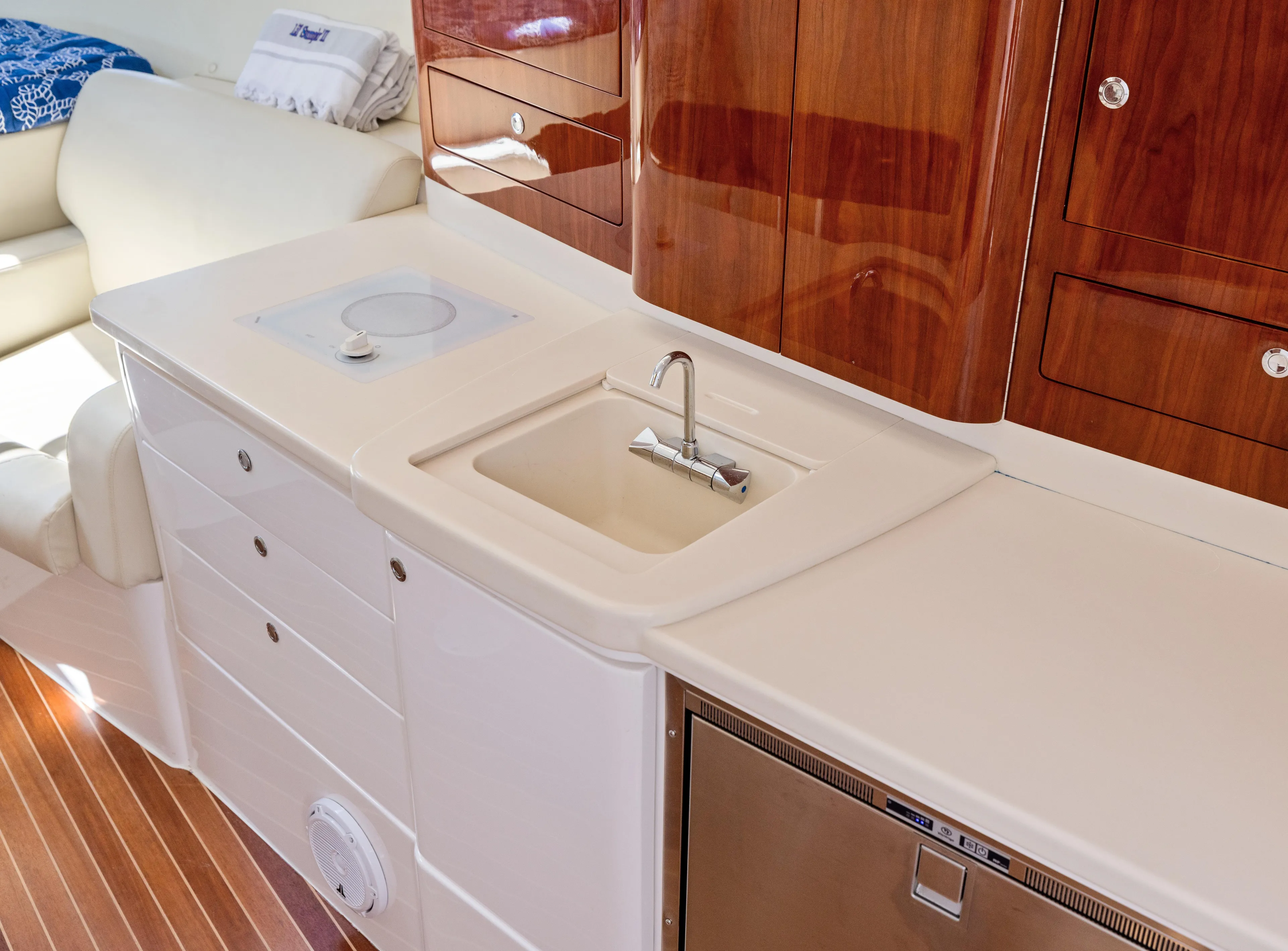 Lil' Sumpin II Yacht Photos Pics Luxurious 2015 Intrepid 430 Sport Yacht interior with sleek kitchenette and wooden cabinetry.